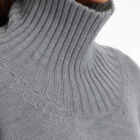 Cropped turtle neck sweater in 100% Extrafine Merino, dropped long sleeves