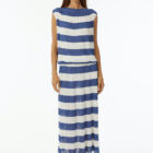 Pleated shiny viscose dress with elastic band at waist, dropped sleeve boat neck. Length at ankle.