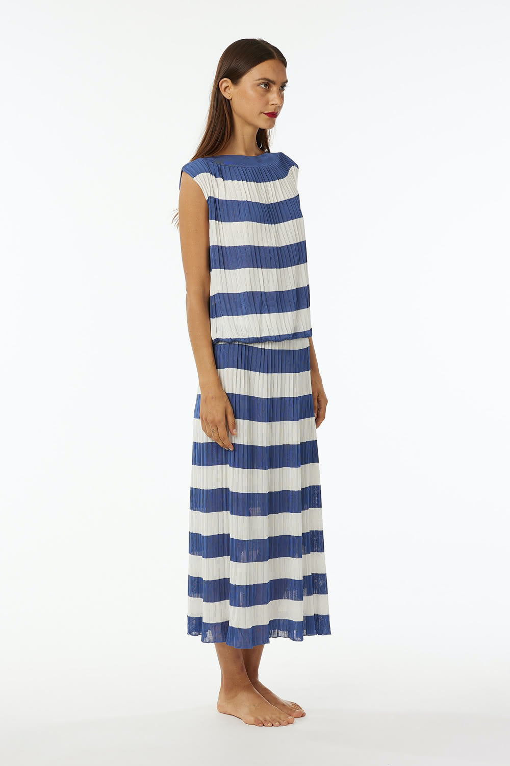 Pleated shiny viscose dress with elastic band at waist, dropped sleeve boat neck. Length at ankle.