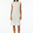 Crew neck sleeveless dress with flat rib, length at knee and cotton fringes at bottom.