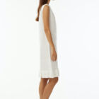 Crew neck sleeveless dress with flat rib, length at knee and cotton fringes at bottom.