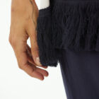 Oversized boat neck sweater with waves intarsia, sleeve at elbow, contrasted color fringes. Wide vestibility.