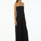 Shoulderless jumpsuit in stretch viscose jersey tight at chest and wider underneath large leg with pockets.