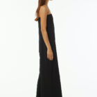 Shoulderless jumpsuit in stretch viscose jersey tight at chest and wider underneath large leg with pockets.