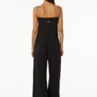 Shoulderless jumpsuit in stretch viscose jersey tight at chest and wider underneath large leg with pockets.