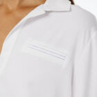 Viscose stretch jersey shirt with long sleeves rounded bottom and small golden buttons.